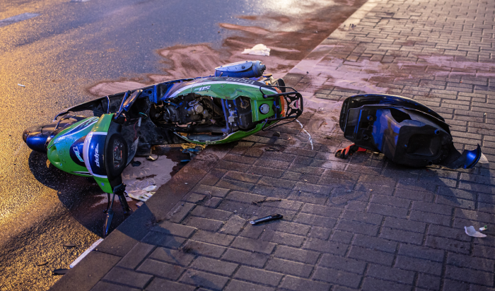 A scooter accident in the morning in the city on an asphalt road